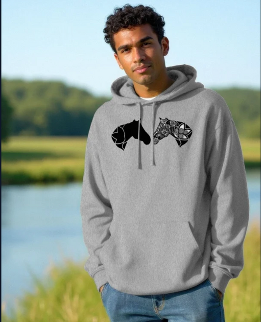 Gray organic cotton hoodie featuring an original black horse and mandala design, modeled outdoors in a natural setting.